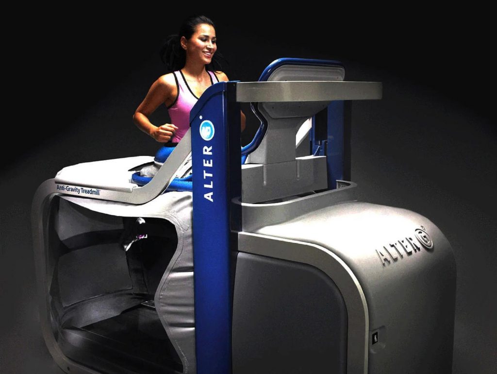 A woman is actively exercising on an Alter G treadmill.