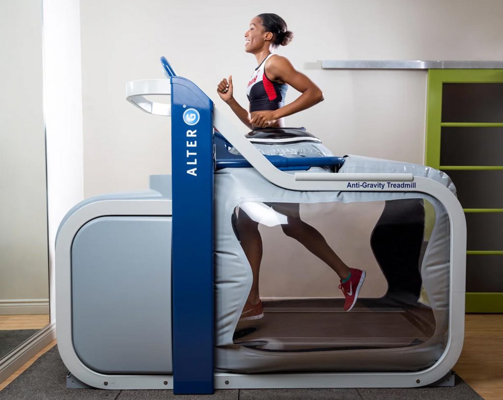 A woman is jogging on an Alter G treadmill.