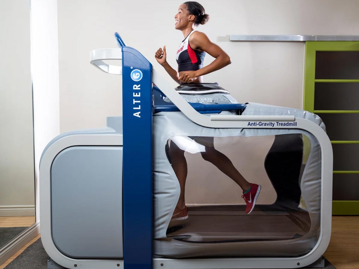 A woman is jogging on an Alter G treadmill.