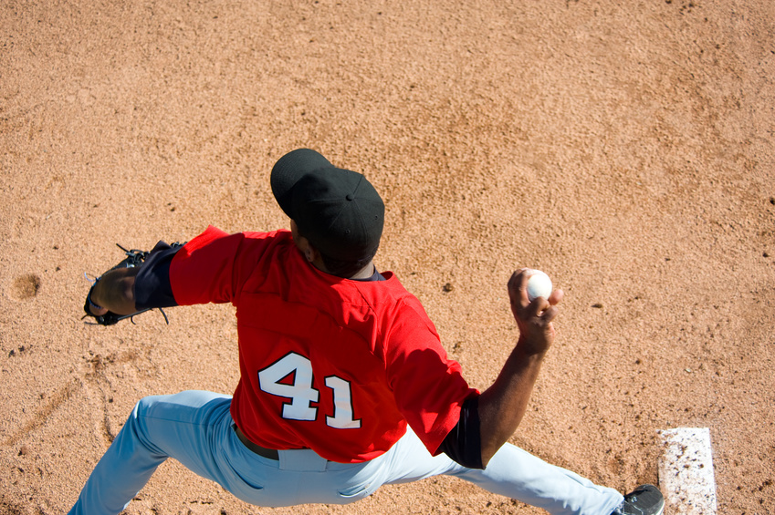 A baseball pitcher throwing a pitch with copy space