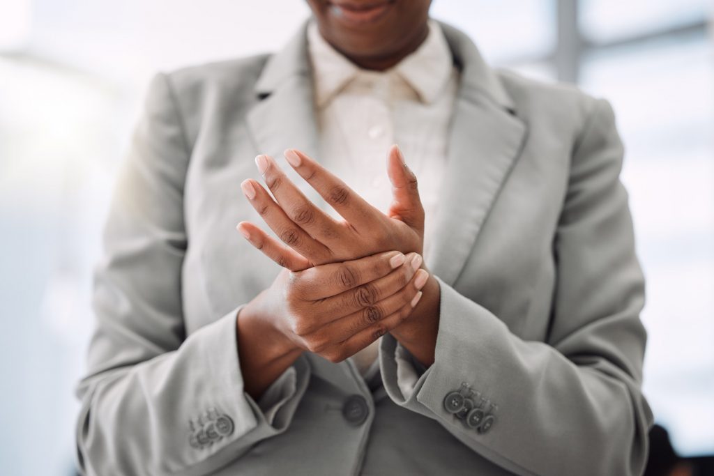 Closeup shot of an unrecognisable businesswoman experiencing hand pain while working in an office