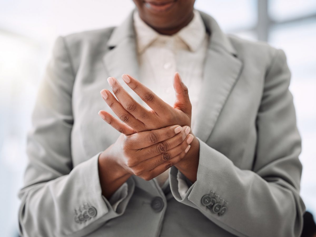Closeup shot of an unrecognisable businesswoman experiencing hand pain while working in an office