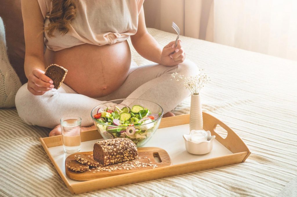 A pregnant lady is enjoying nutritious meals