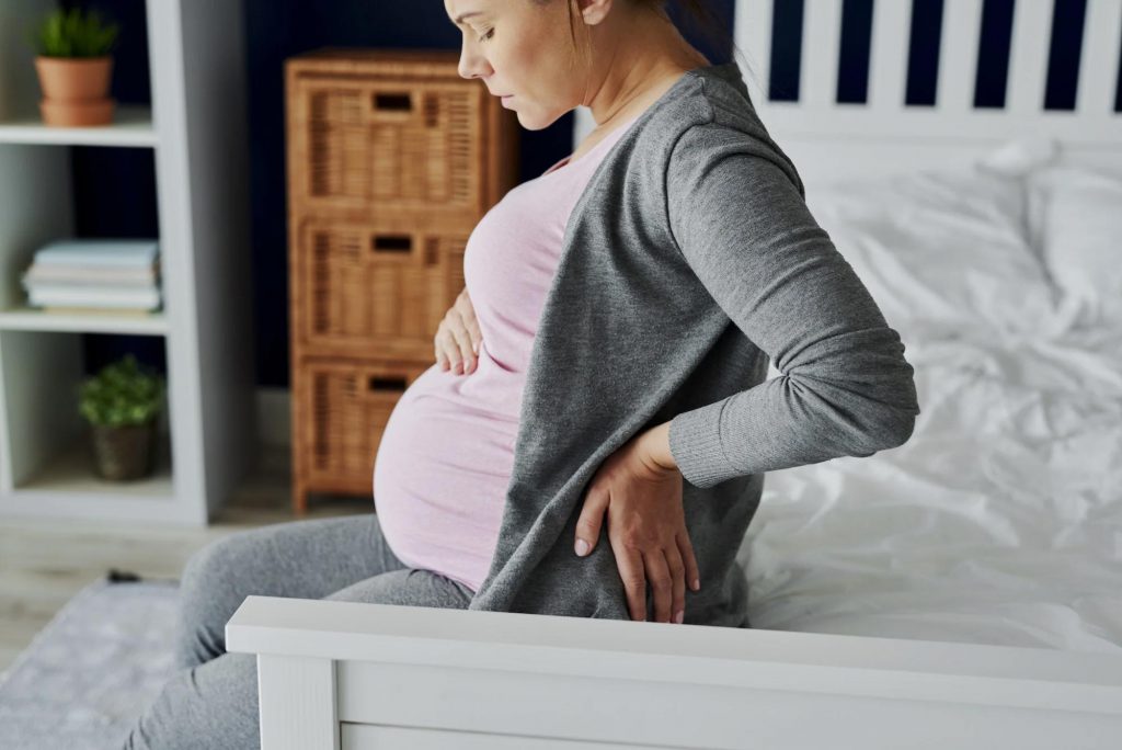 A pregnant woman is experiencing back pain