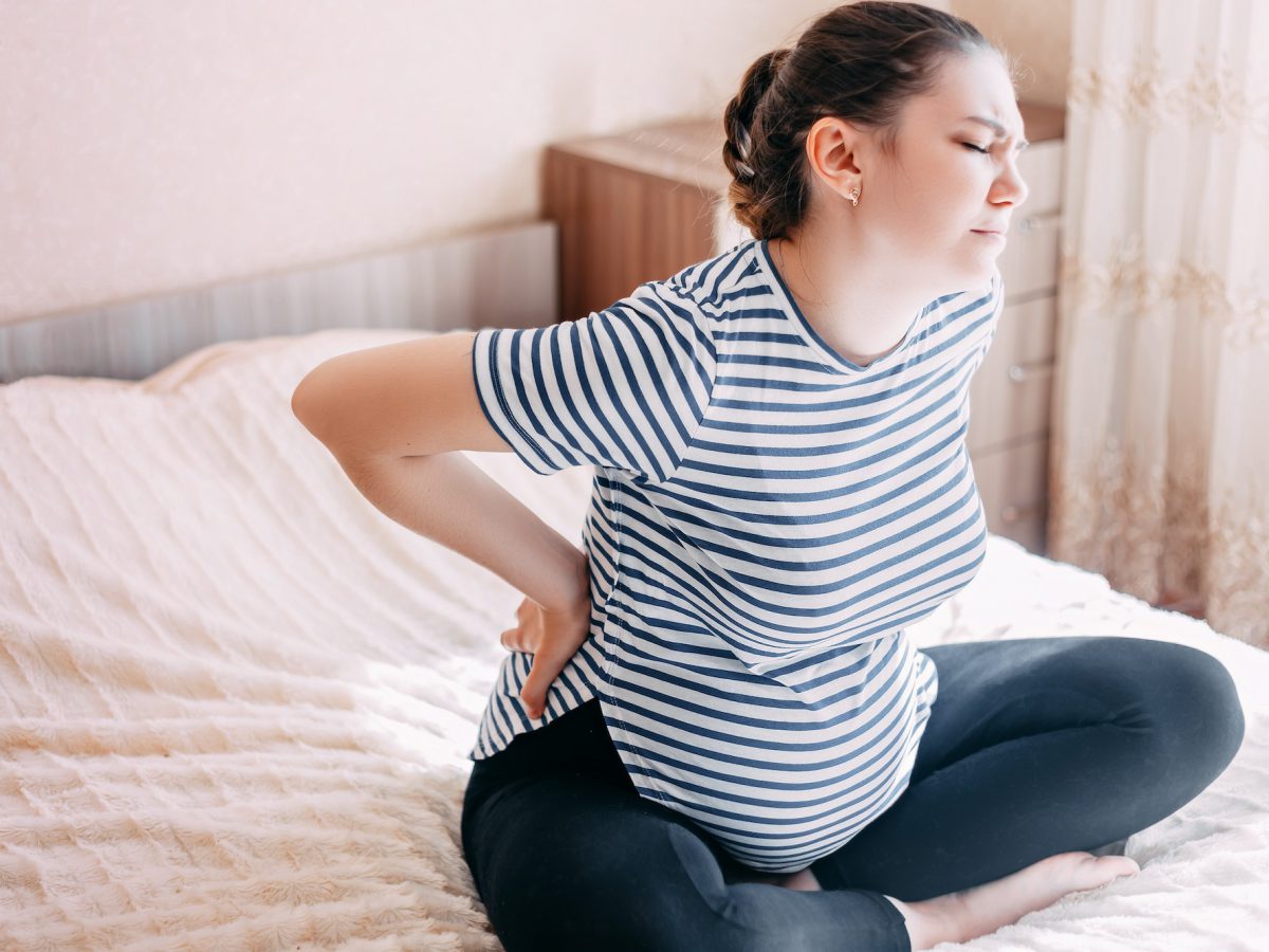 Pregnant woman having back aches, pain