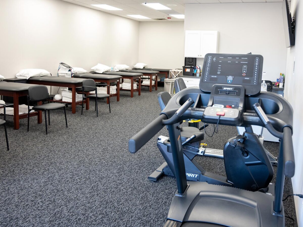 SportsMed Physical Therapy - Belleville, New Jersey - physical therapy room with tables and treadmill