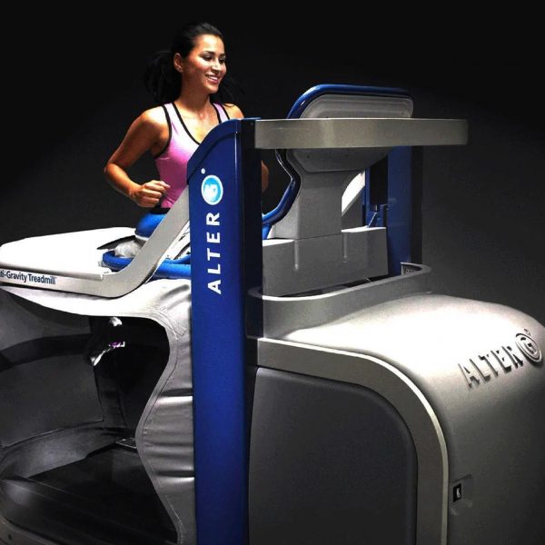 A woman is actively exercising on an Alter G treadmill.