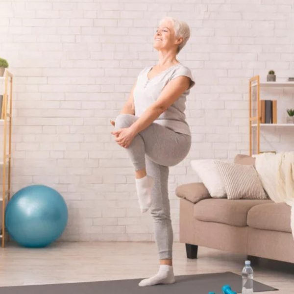 An older woman working on her balance with exercises.